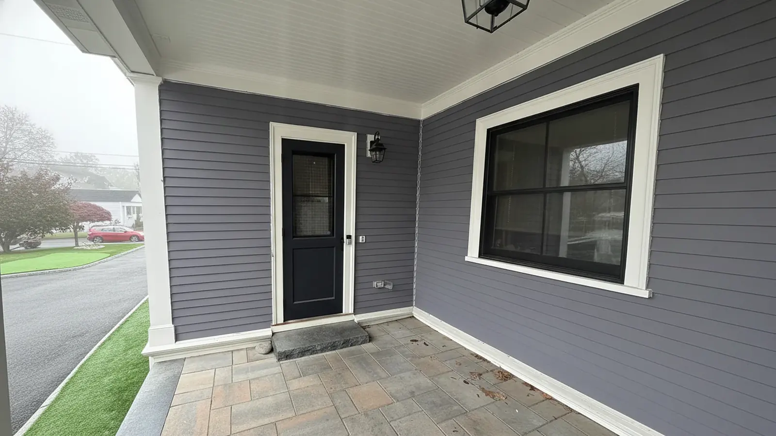 Covered porch with gray siding and white trim