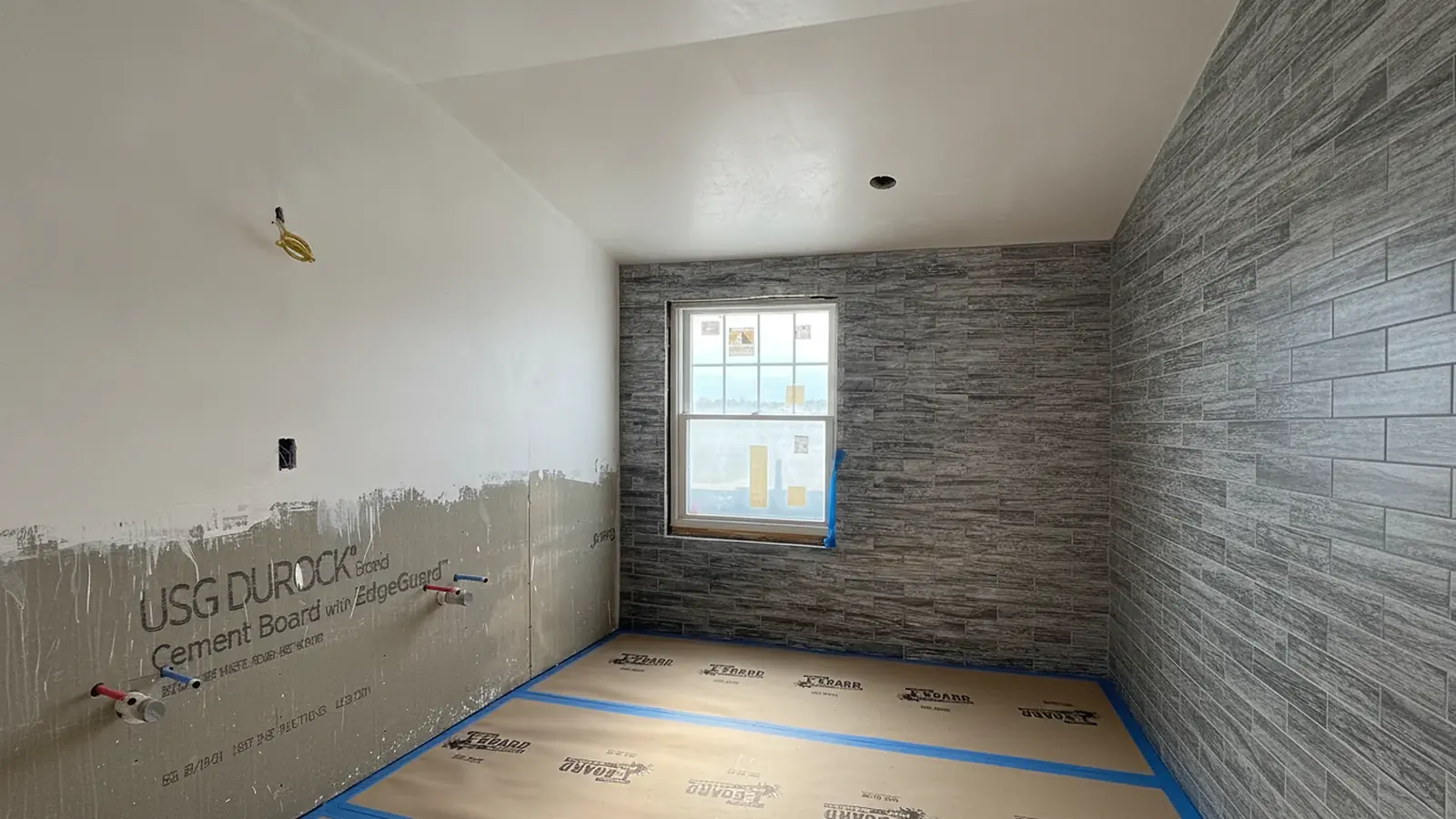 Interior wall prep in progress with floors protected