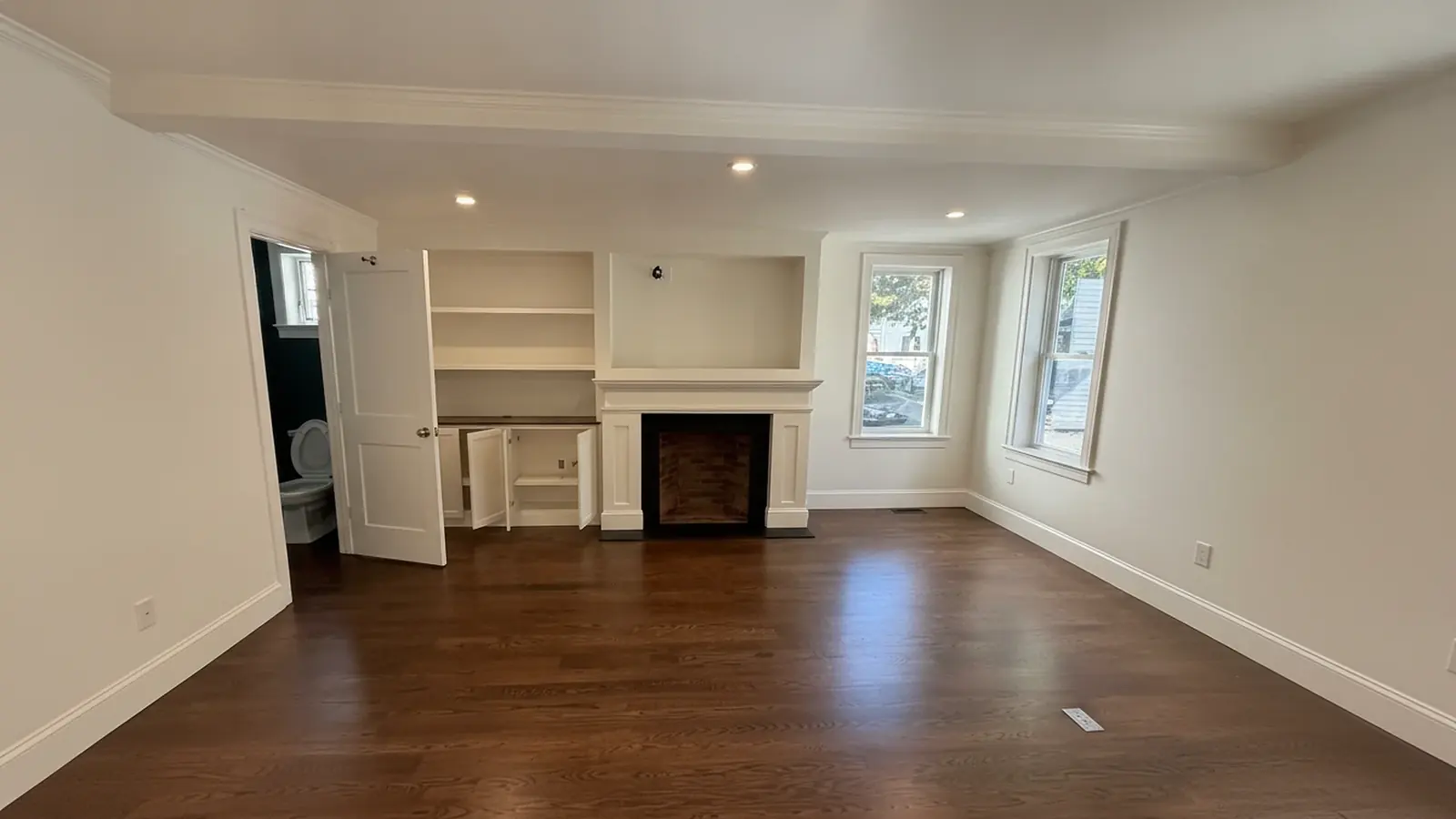 Living room with painted fireplace wall and built-ins