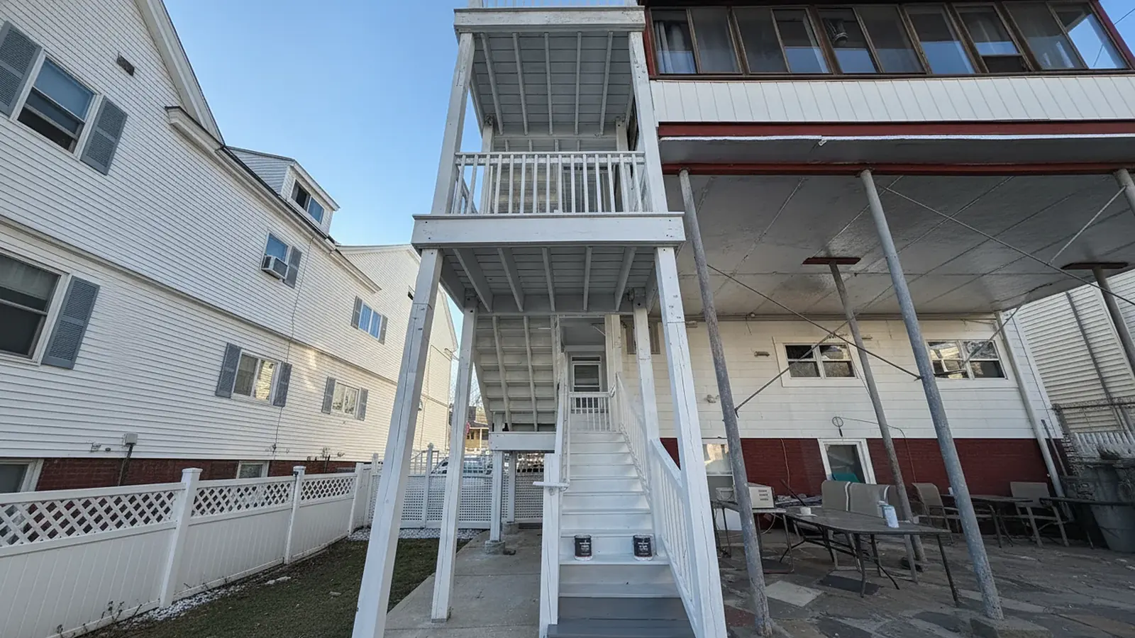 Multi-level back porch in white after cleaning and painting