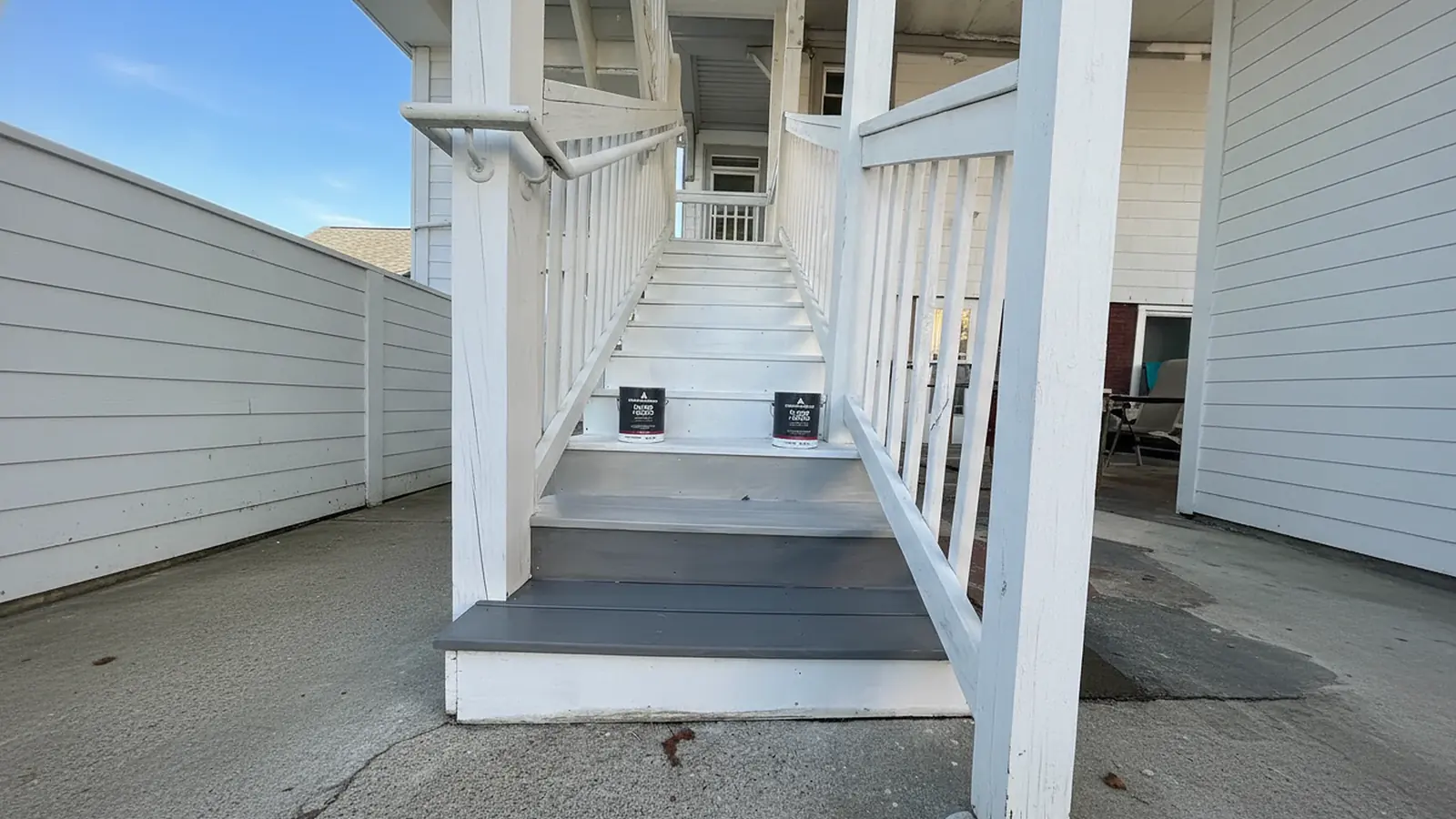 Porch stairs in gray and white after washing and painting