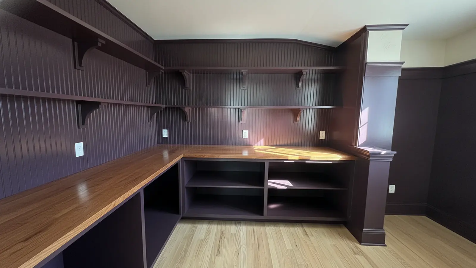 Home office with plum painted built-in cabinets