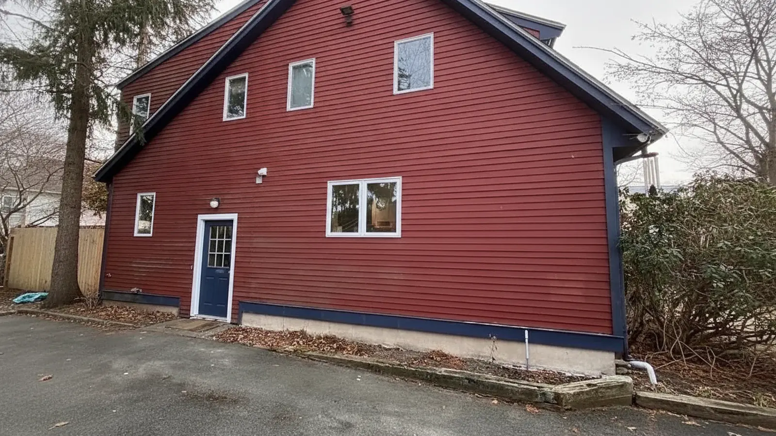 Red barn style house with painted wood siding and white trim