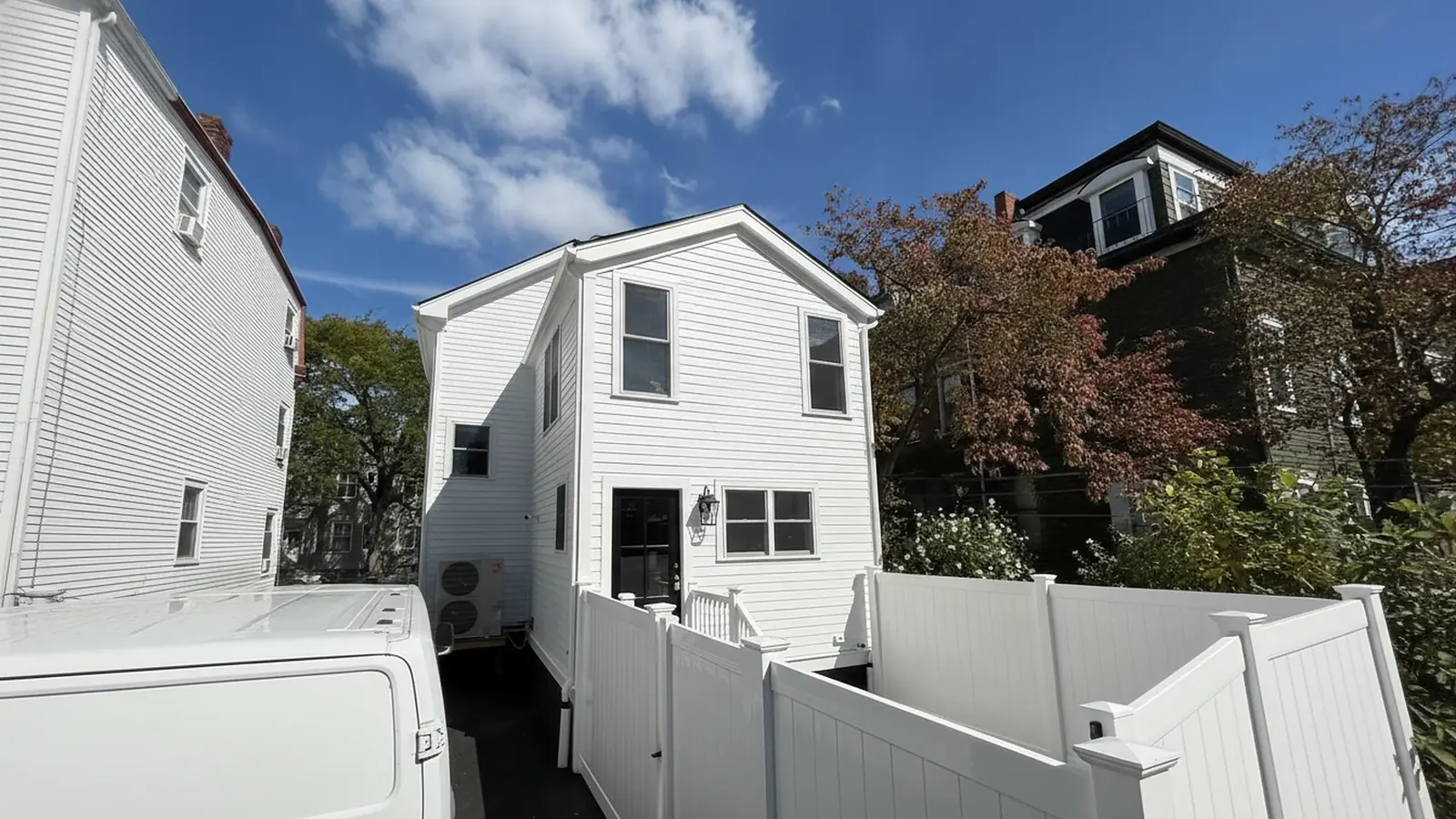 White house rear exterior with gutters and trim
