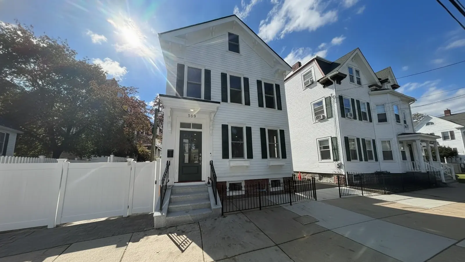 White colonial house exterior with black shutters